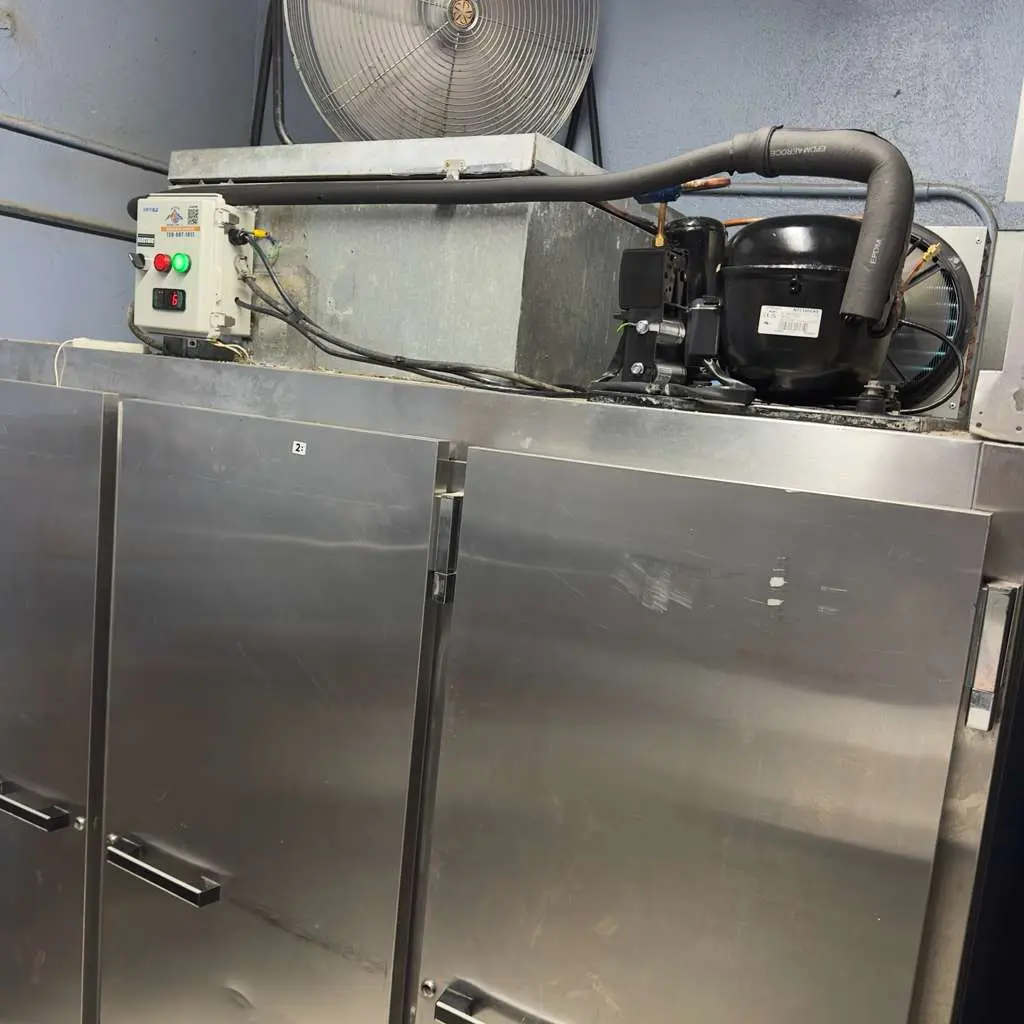 Compressor of a commercial reach-in refrigerator during service